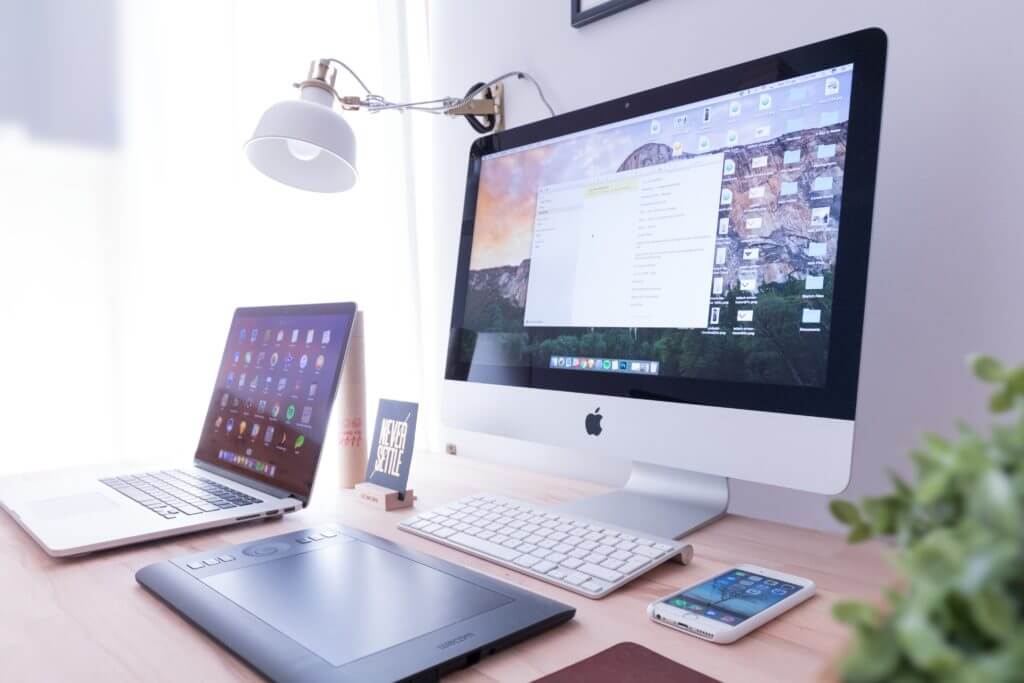 Frequently asked questions regarding PWA vs. MPA vs. SPA displayed on monitor of white apple computer.