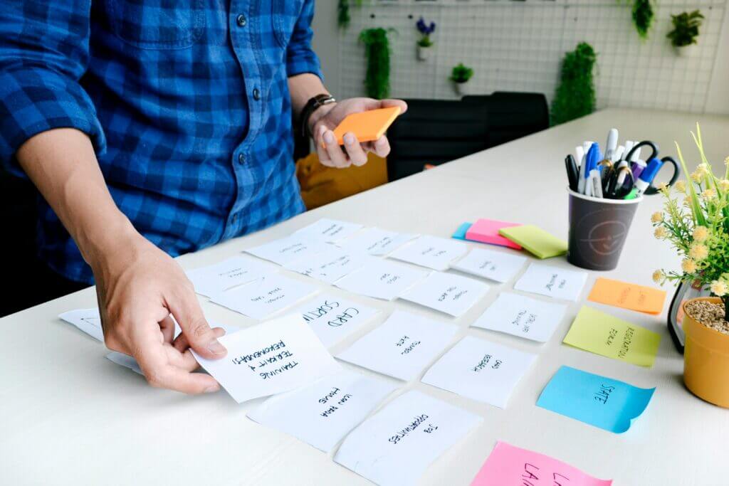 project management - a person working with the sticky notes