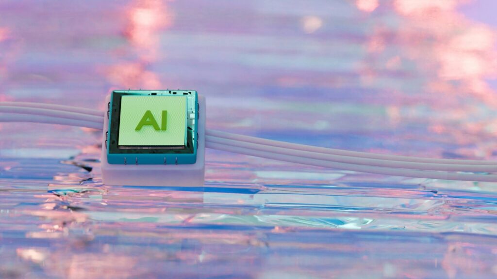 A close-up of a central processor with the text 'AI' on a reflective, wave-like surface, illustrating the technological core that must be regulated by proper AI governance structures.